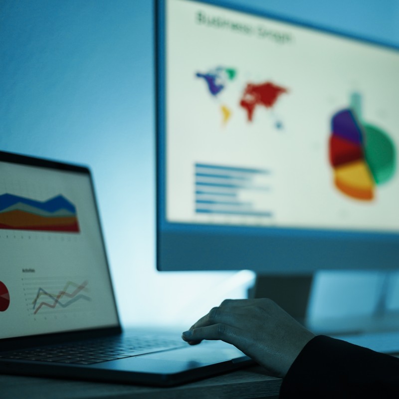 Young woman analyzing data charts for marketing financial reports - Focus on left hand